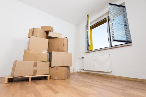 Packed office equipment and furniture ready for relocation in Harringay
