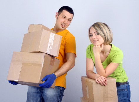 Removal team handling furniture during a move in Harringay
